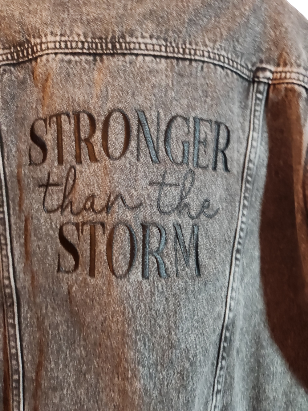Gray Denim Jean Jacket with 'Stronger Than The Storm' Back Graphic